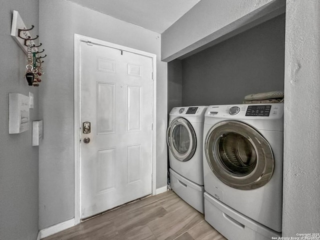 4338 Golden Spice, San Antonio, TX 78222 - laundry area with washer and clothes dryer and light wood-type flooring