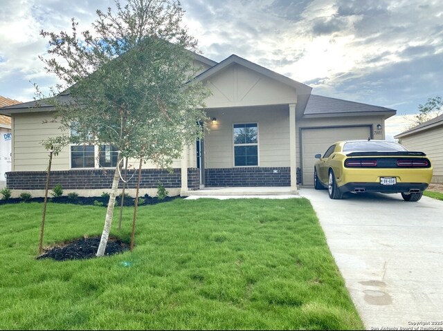7003 Emerald Vly, San Antonio, TX 78242 - view of front of house with an attached garage, driveway, brick siding, a front yard, and covered porch