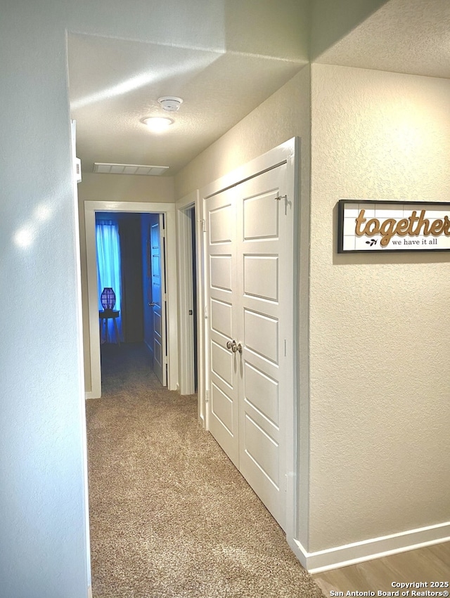 7003 Emerald Vly, San Antonio, TX 78242 - hallway featuring a textured wall and carpet flooring