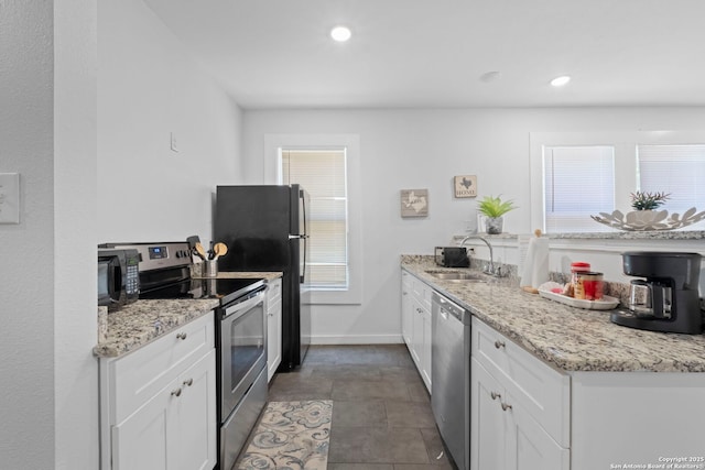 402 E Dewey, San Antonio, TX 78212 - kitchen featuring stainless steel appliances, a sink, white cabinetry, recessed lighting, and light stone countertops