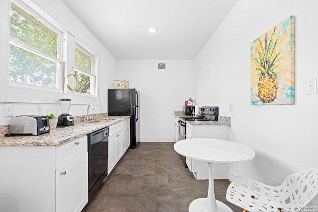 402 E Dewey, San Antonio, TX 78212 - kitchen with black dishwasher, a sink, freestanding refrigerator, electric range, and white cabinets