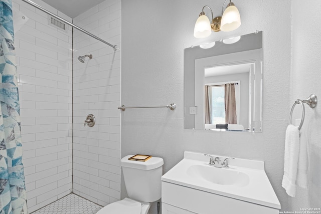 402 E Dewey, San Antonio, TX 78212 - bathroom with vanity, a tile shower, and toilet
