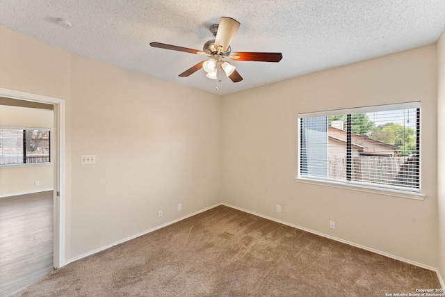 5626 Spring Sunshine, San Antonio, TX 78247 - empty room with plenty of natural light, carpet floors, a textured ceiling, a ceiling fan, and baseboards