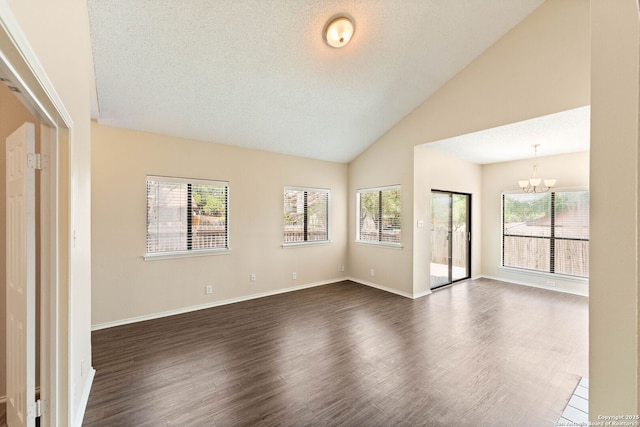 5626 Spring Sunshine, San Antonio, TX 78247 - empty room featuring a chandelier, dark wood finished floors, healthy amount of natural light, high vaulted ceiling, and baseboards