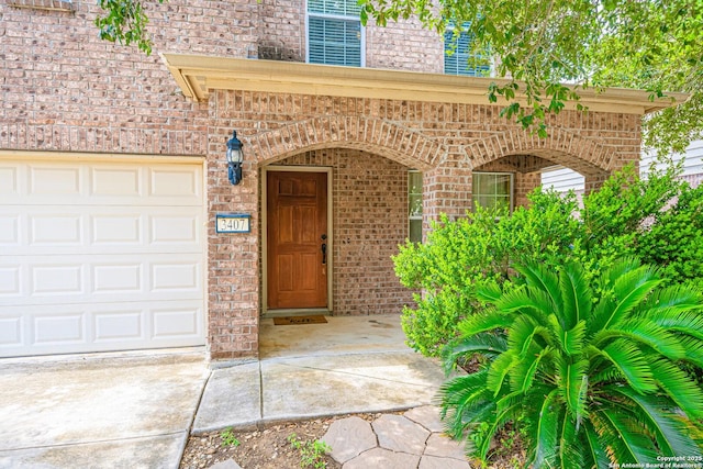 3407 Maguey Trl, San Antonio, TX 78245 - doorway to property featuring brick siding and an attached garage