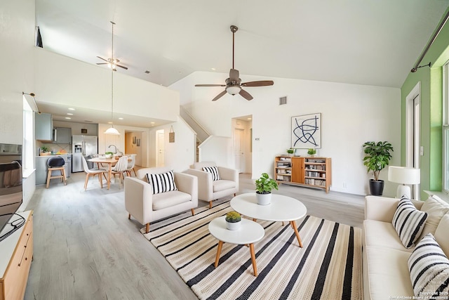 3407 Maguey Trl, San Antonio, TX 78245 - living area with light wood-style flooring, a ceiling fan, and high vaulted ceiling