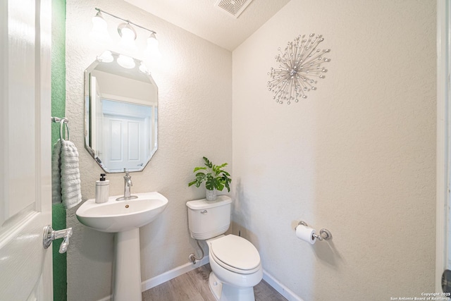 3407 Maguey Trl, San Antonio, TX 78245 - half bathroom with toilet and wood finished floors