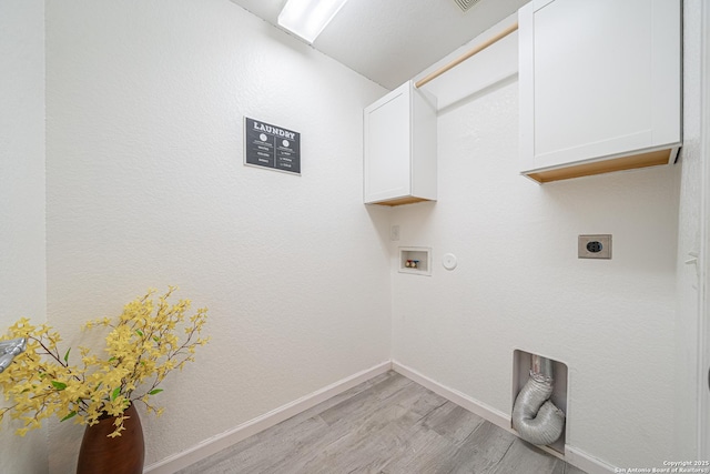 3407 Maguey Trl, San Antonio, TX 78245 - laundry room with electric dryer hookup, cabinet space, light wood-style floors, hookup for a washing machine, and baseboards