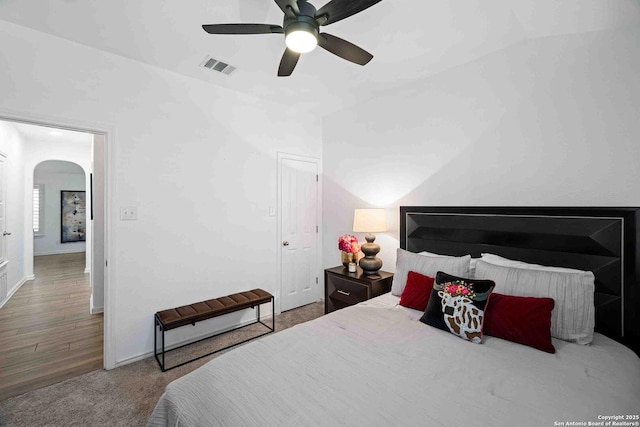 3714 Cotoneaster, San Antonio, TX 78261 - bedroom featuring arched walkways, a ceiling fan, baseboards, and wood finished floors