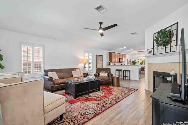3714 Cotoneaster, San Antonio, TX 78261 - living area with light wood-type flooring, ceiling fan, and a fireplace