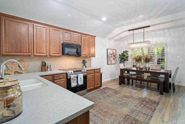 3714 Cotoneaster, San Antonio, TX 78261 - kitchen featuring black microwave, stainless steel range with electric stovetop, a sink, baseboards, and vaulted ceiling