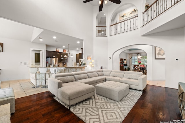 846 Fawnway, San Antonio, TX 78260 - living room featuring arched walkways, a ceiling fan, light wood finished floors, a towering ceiling, and recessed lighting