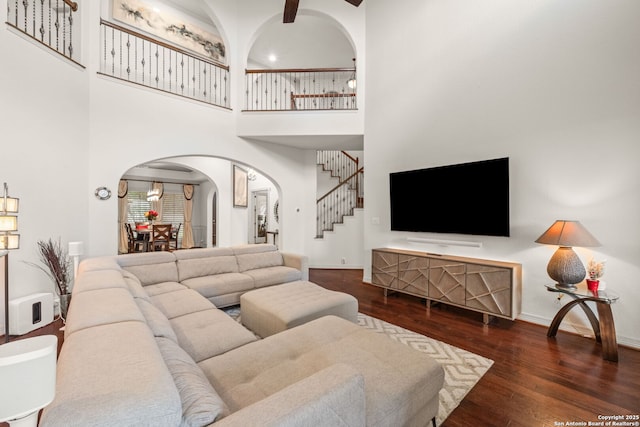 846 Fawnway, San Antonio, TX 78260 - living room featuring arched walkways, stairs, wood-type flooring, a high ceiling, and baseboards