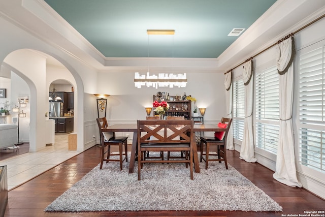 846 Fawnway, San Antonio, TX 78260 - dining space with a tray ceiling, arched walkways, and hardwood / wood-style flooring