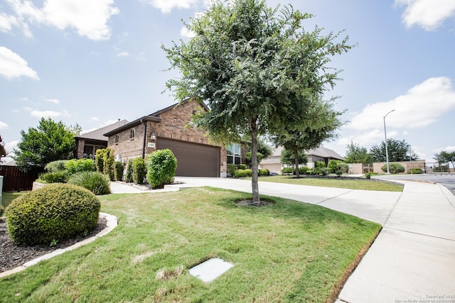 12805 Big Tank Rnch, San Antonio, TX 78245 - view of front of home featuring driveway, brick siding, a front lawn, and a garage