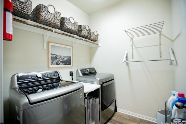 12805 Big Tank Rnch, San Antonio, TX 78245 - laundry room featuring washing machine and dryer, wood finished floors, and baseboards