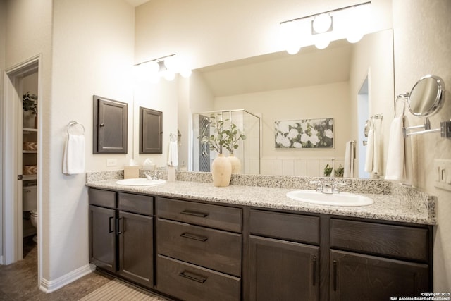 12805 Big Tank Rnch, San Antonio, TX 78245 - full bath with double vanity, a stall shower, toilet, and tile patterned floors