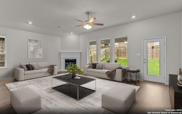 6415 Morgan Gln, San Antonio, TX 78253 - living room with ceiling fan, wood finished floors, a glass covered fireplace, recessed lighting, and baseboards