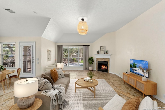 1015 Water Lily, San Antonio, TX 78260 - living room featuring lofted ceiling, a tile fireplace, light tile patterned floors, and baseboards