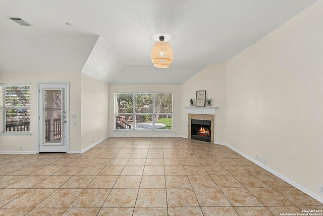 1015 Water Lily, San Antonio, TX 78260 - unfurnished living room featuring healthy amount of natural light, vaulted ceiling, a fireplace, light tile patterned flooring, and baseboards