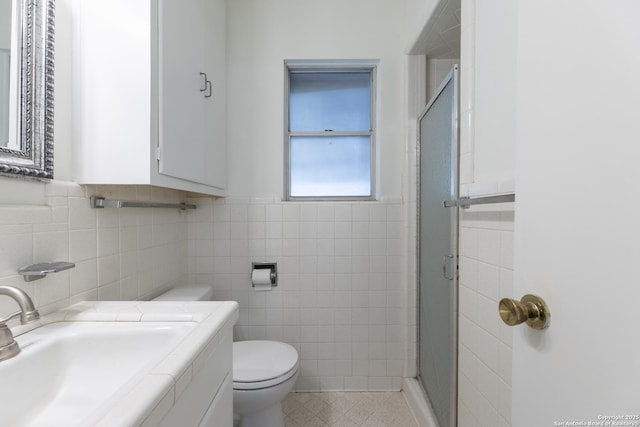 4326 Hall Park, San Antonio, TX 78218 - bathroom with tile walls, toilet, a stall shower, vanity, and a wainscoted wall
