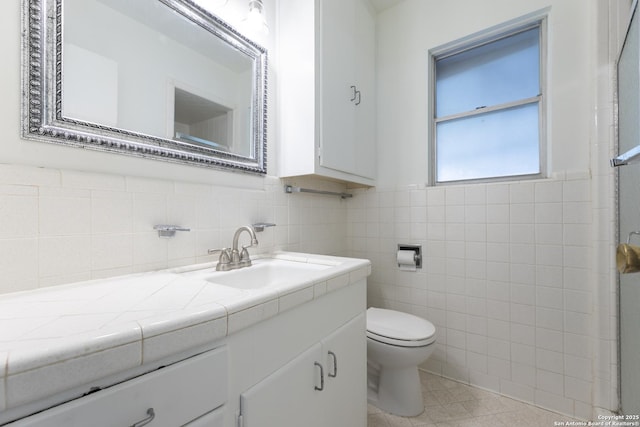 4326 Hall Park, San Antonio, TX 78218 - bathroom featuring vanity, toilet, and tile walls