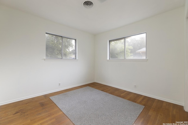 4326 Hall Park, San Antonio, TX 78218 - empty room featuring healthy amount of natural light, baseboards, and wood finished floors