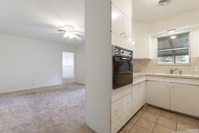 4326 Hall Park, San Antonio, TX 78218 - kitchen with oven, a sink, light countertops, ceiling fan, and white cabinets