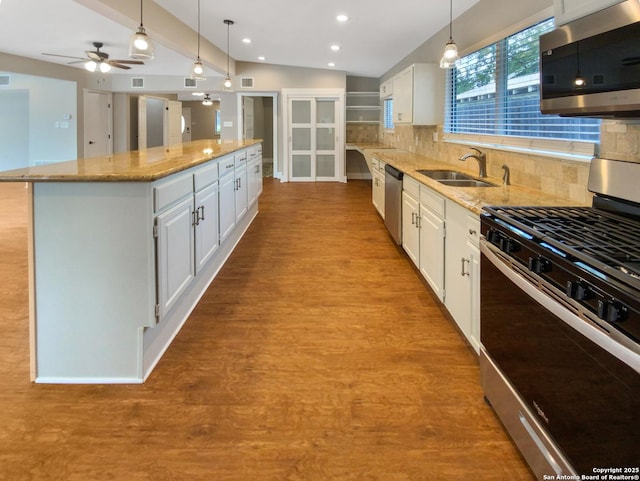 1002 Chevy Chase, San Antonio, TX 78209 - kitchen with stainless steel appliances, a sink, a kitchen island, white cabinets, and light stone countertops