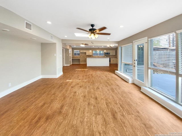 1002 Chevy Chase, San Antonio, TX 78209 - unfurnished living room featuring light wood-style floors, a ceiling fan, baseboards, and recessed lighting