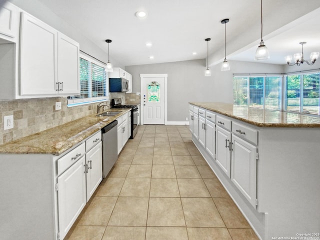 1002 Chevy Chase, San Antonio, TX 78209 - kitchen with stainless steel appliances, a sink, decorative backsplash, a kitchen island, and white cabinets