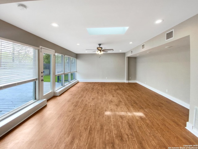 1002 Chevy Chase, San Antonio, TX 78209 - empty room with a skylight, light wood-style flooring, a ceiling fan, baseboards, and recessed lighting