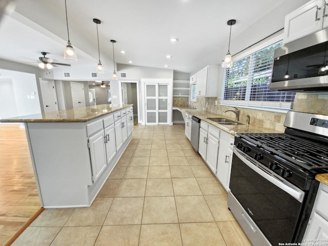 1002 Chevy Chase, San Antonio, TX 78209 - kitchen featuring appliances with stainless steel finishes, a center island, ceiling fan, tasteful backsplash, and a sink