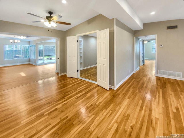 1002 Chevy Chase, San Antonio, TX 78209 - empty room featuring ceiling fan, light wood-style flooring, baseboards, a chandelier, and vaulted ceiling