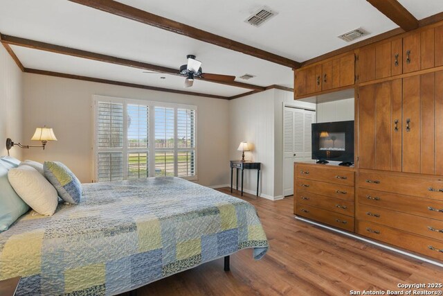 701 Steele, Smiley, TX 78159 - bedroom with wood finished floors, beam ceiling, baseboards, ornamental molding, and a ceiling fan