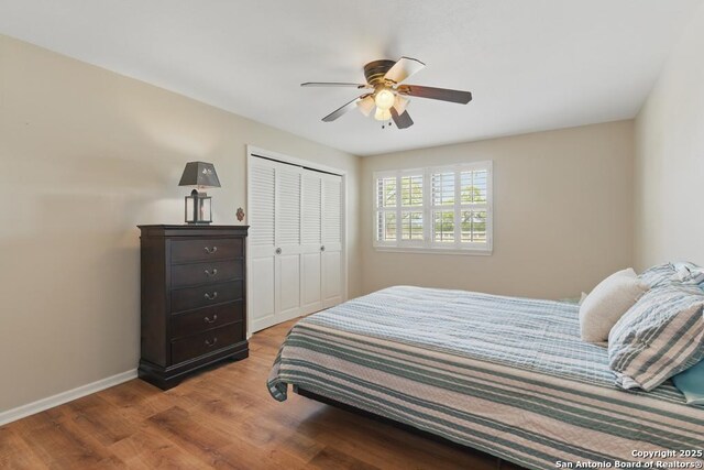 701 Steele, Smiley, TX 78159 - bedroom featuring wood finished floors, a closet, baseboards, and a ceiling fan