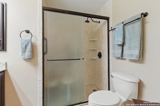 701 Steele, Smiley, TX 78159 - full bathroom with toilet, vanity, and a stall shower