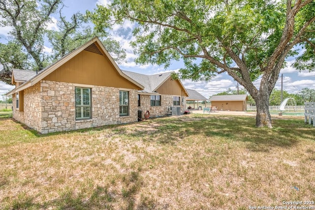 701 Steele, Smiley, TX 78159 - rear view of house with stone siding and central AC unit