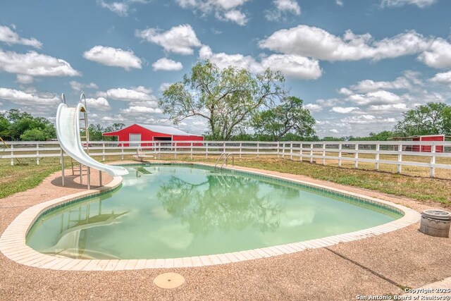 701 Steele, Smiley, TX 78159 - view of pool featuring a water slide and an outdoor structure