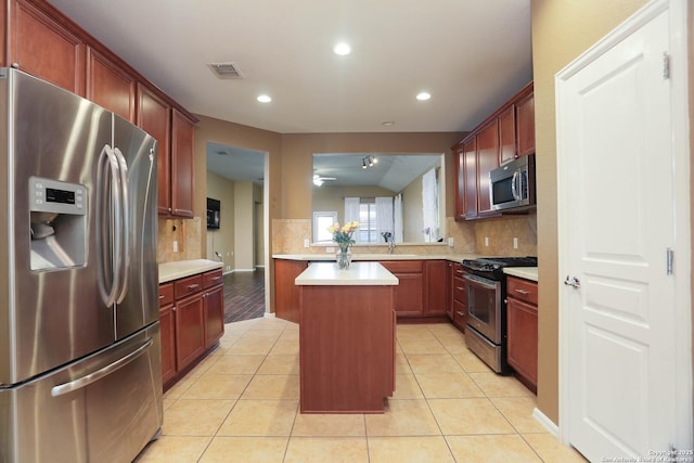 3410 Port Pl, San Antonio, TX 78253 - kitchen featuring appliances with stainless steel finishes, tasteful backsplash, light countertops, a kitchen island, and recessed lighting
