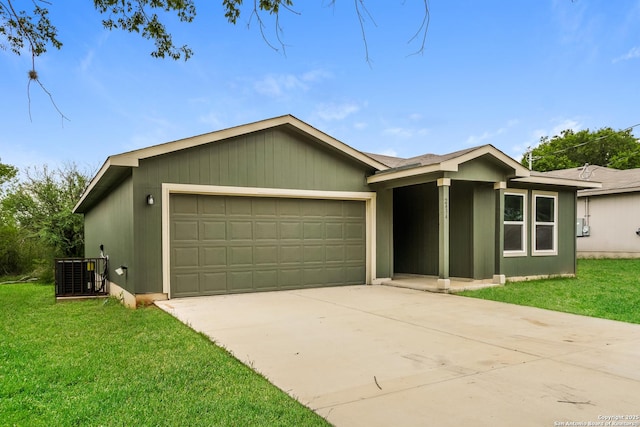 2434 Bermuda, San Antonio, TX 78222 - view of front of home with an attached garage, cooling unit, concrete driveway, and a front lawn