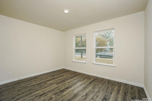 2434 Bermuda, San Antonio, TX 78222 - unfurnished room featuring dark wood-style floors, baseboards, and recessed lighting