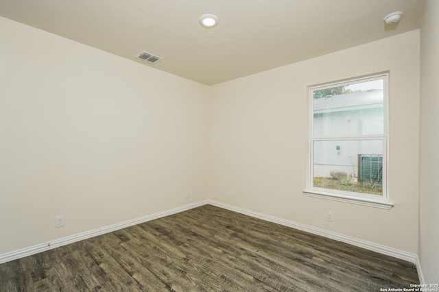 2434 Bermuda, San Antonio, TX 78222 - spare room with baseboards, dark wood finished floors, and a smoke detector