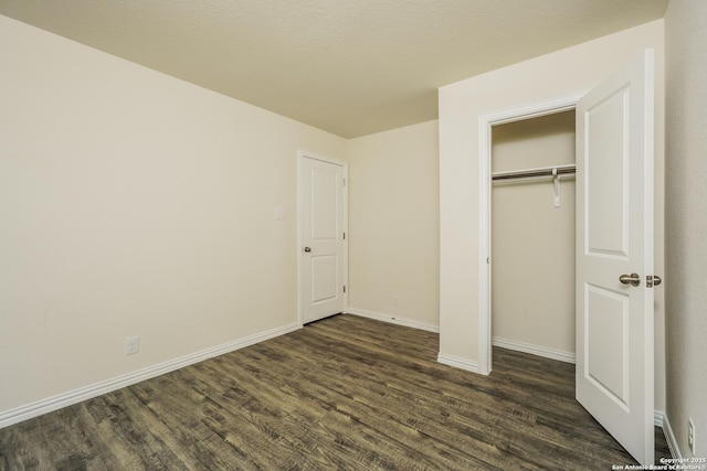 2434 Bermuda, San Antonio, TX 78222 - unfurnished bedroom with dark wood-type flooring, baseboards, and a closet