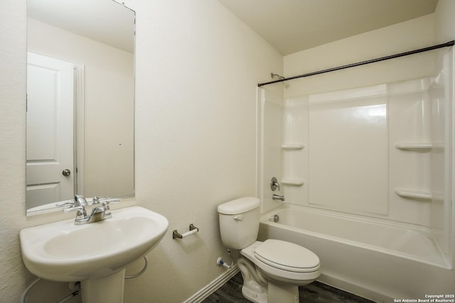 2434 Bermuda, San Antonio, TX 78222 - bathroom with baseboards, toilet, wood finished floors, shower / bath combination, and a sink