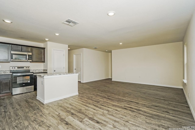 2434 Bermuda, San Antonio, TX 78222 - kitchen with appliances with stainless steel finishes, dark wood-type flooring, open floor plan, a kitchen island, and recessed lighting