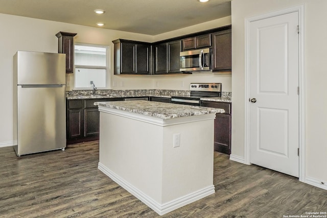 2434 Bermuda, San Antonio, TX 78222 - kitchen featuring appliances with stainless steel finishes, a center island, dark wood finished floors, a sink, and recessed lighting