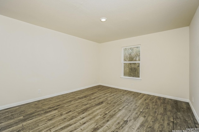 2434 Bermuda, San Antonio, TX 78222 - spare room featuring wood finished floors, baseboards, and recessed lighting