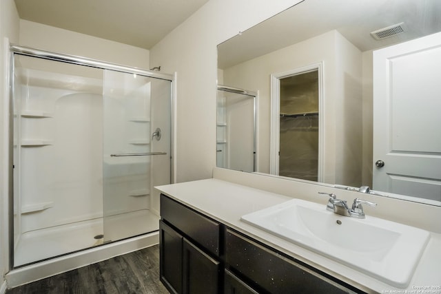 2434 Bermuda, San Antonio, TX 78222 - full bathroom with a shower stall, wood finished floors, vanity, and a walk in closet