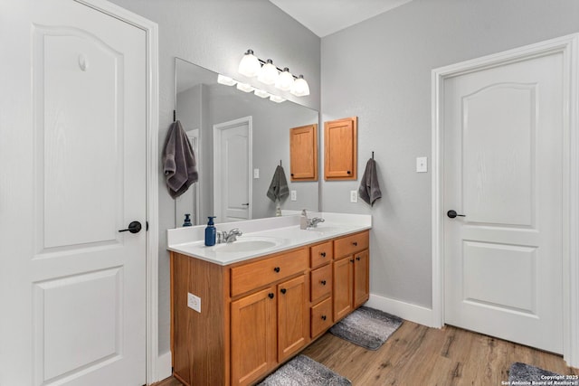 24719 Alamosa Fls, San Antonio, TX 78255 - full bath with wood finished floors, double vanity, and baseboards